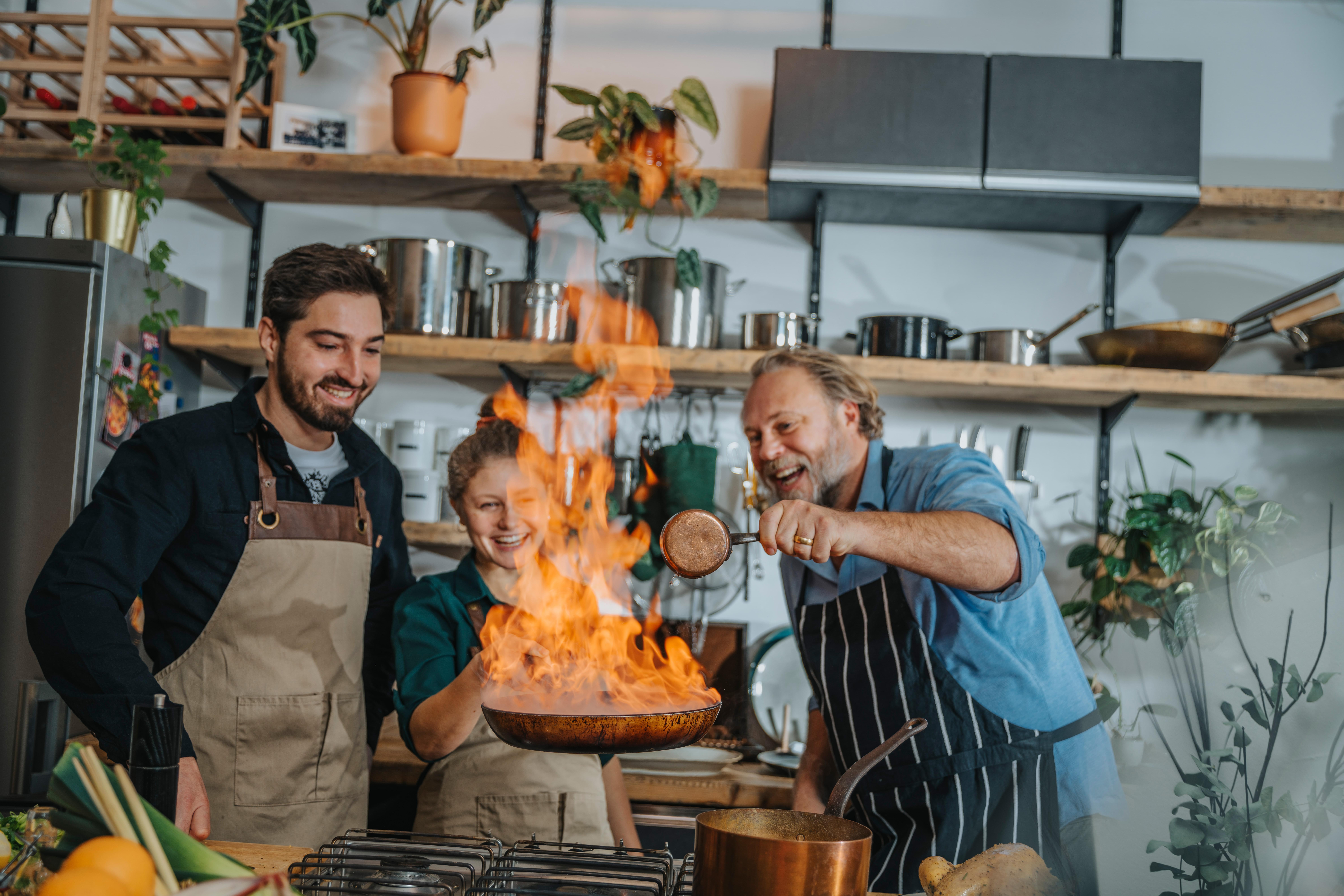 Chefs jokingly flaming pan, Koeln, NRW, Germany