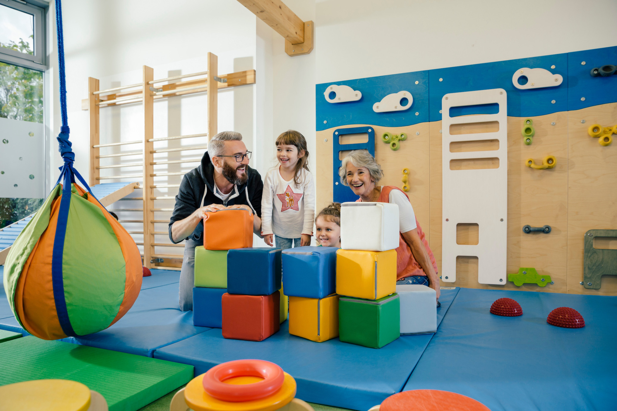 Children and teachers posing in gym room of  Daycare center, Pre-school or Kindergarten, Cologne, NRW, Germany