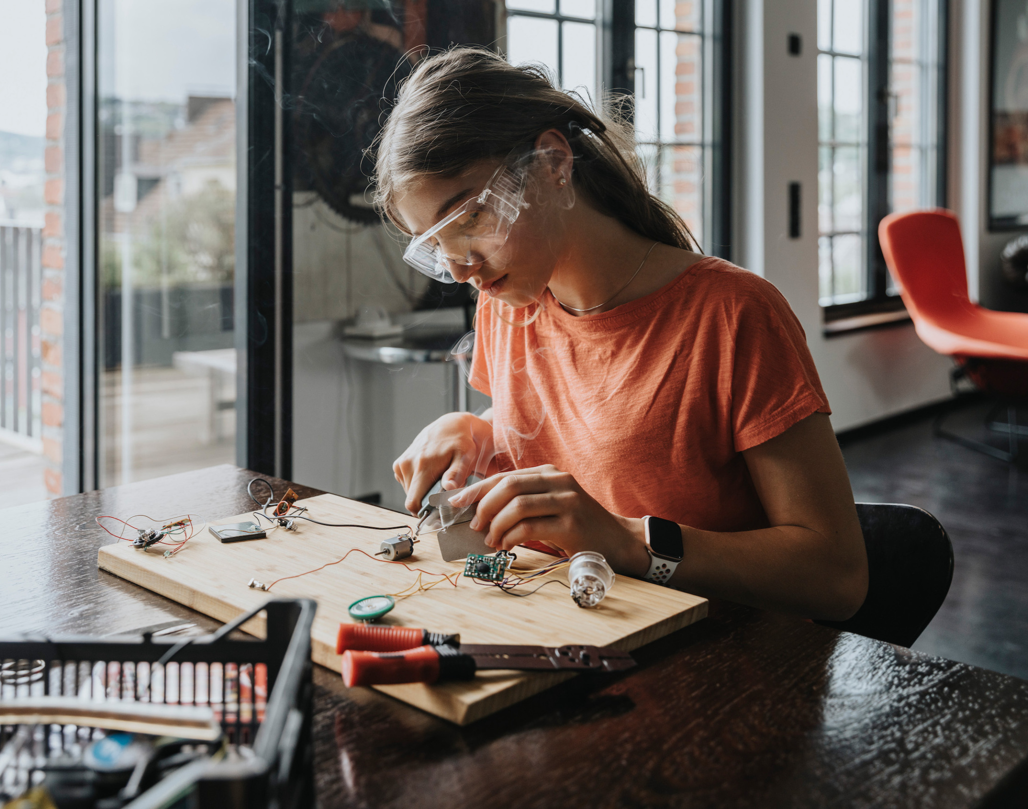 Teenager working with soldering iron at home, Wuppertal, NRW, Germany