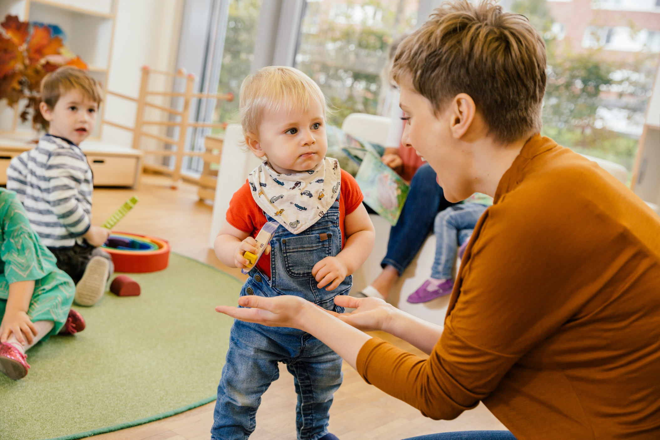 Pre-school teacher playing with small boy in Daycare center, Pre-school or Kindergarten, Cologne, NRW, Germany