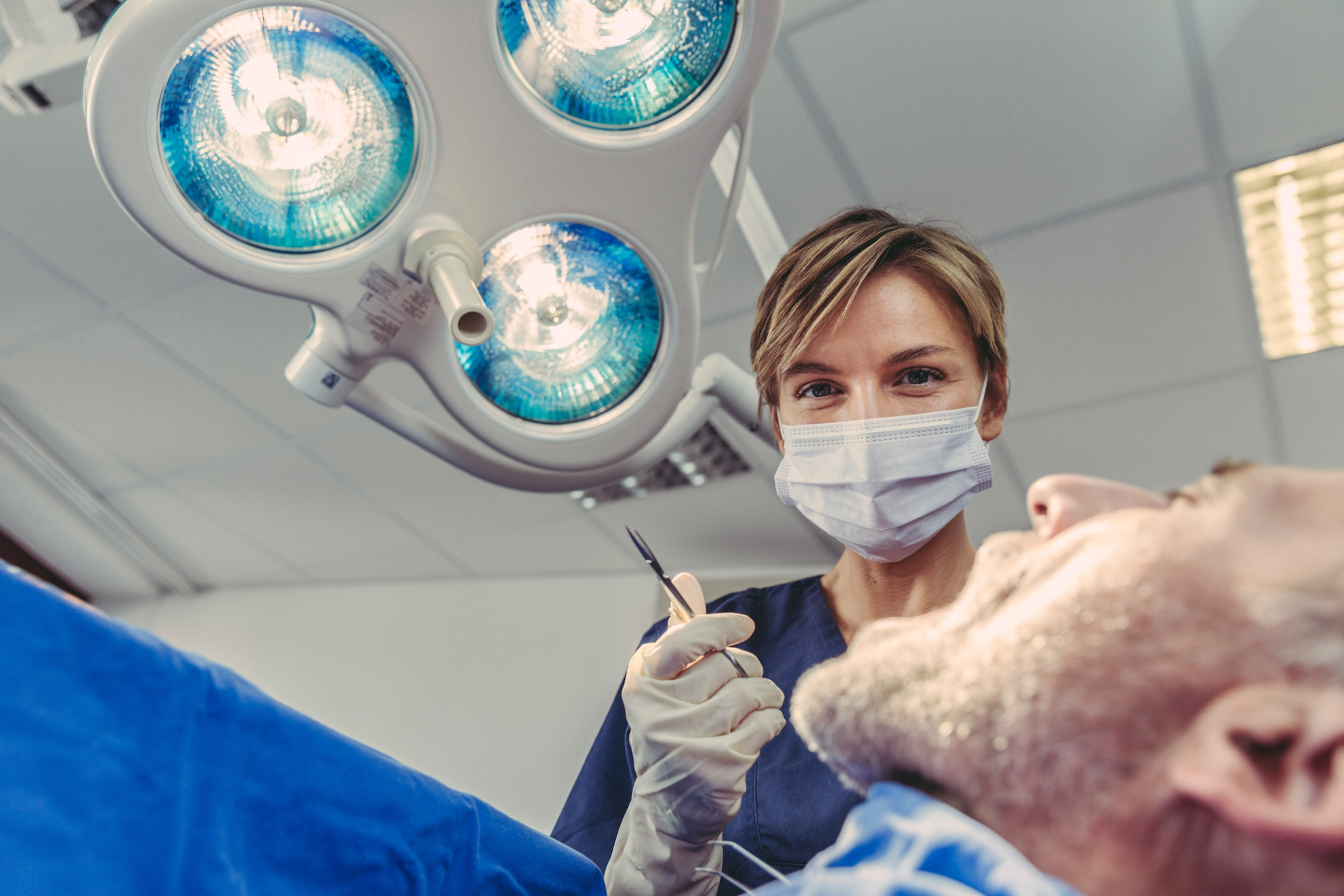Operating dental surgeon during procedure, Germany