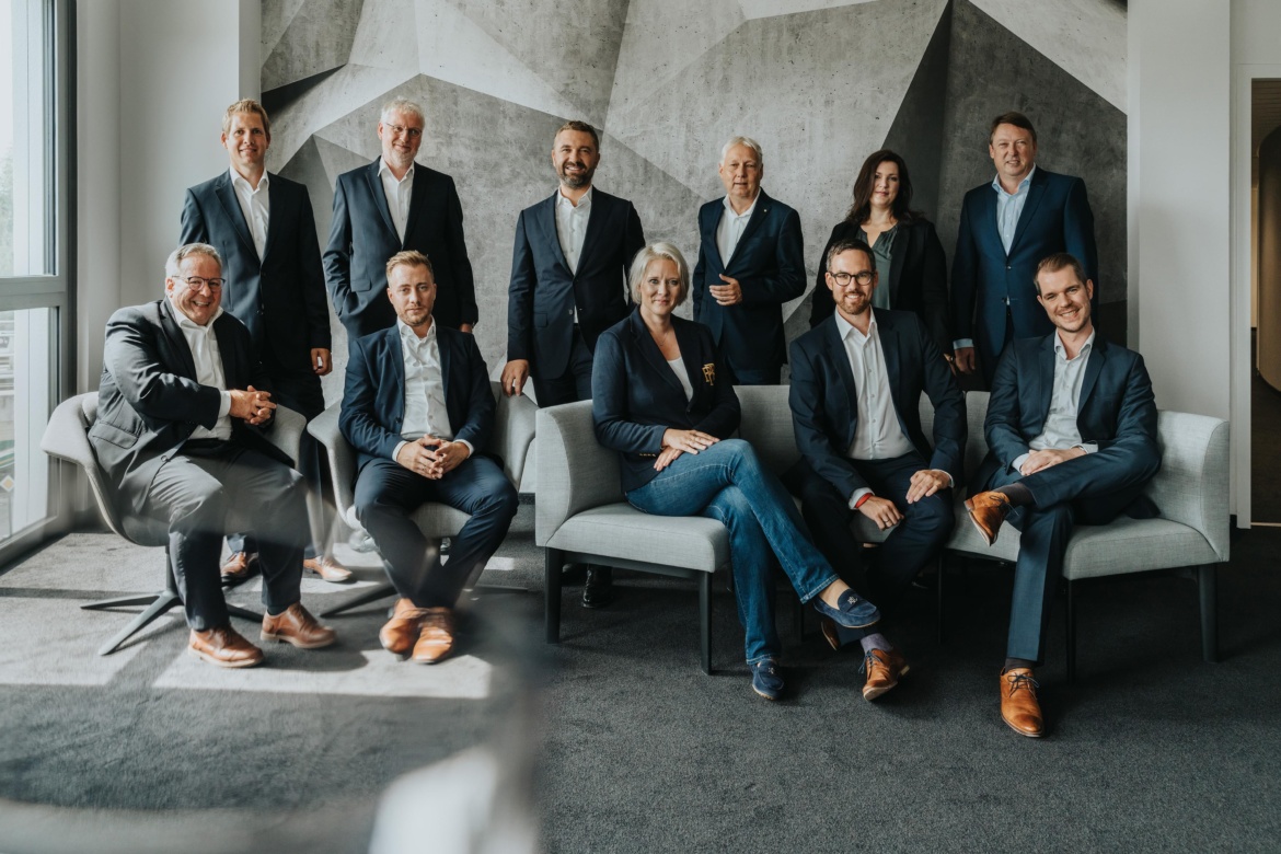 Professional business team posing in modern office setting by Mareen Fischinger