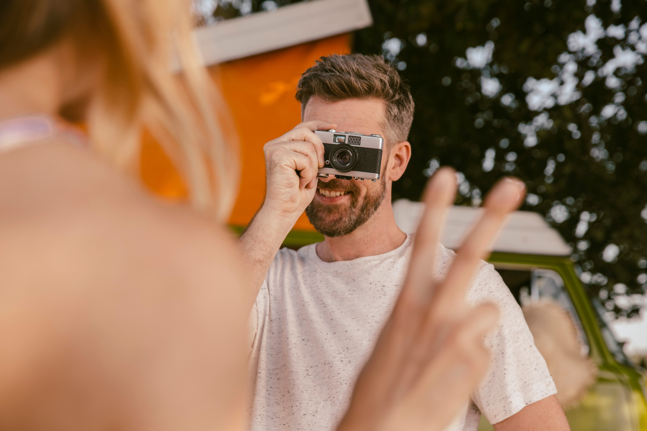 Man taking an analog photo of his girlfriend on their summer trip through North Rhine-Westfalia, Germany
