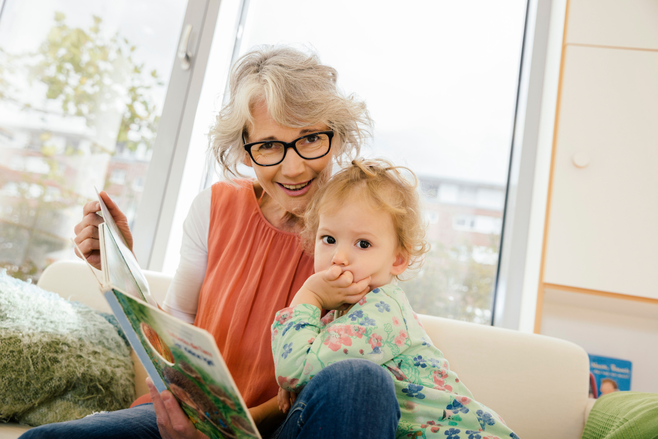 Pre-school teacher reading with child in Daycare center, Pre-school or Kindergarten, Cologne, NRW, Germany