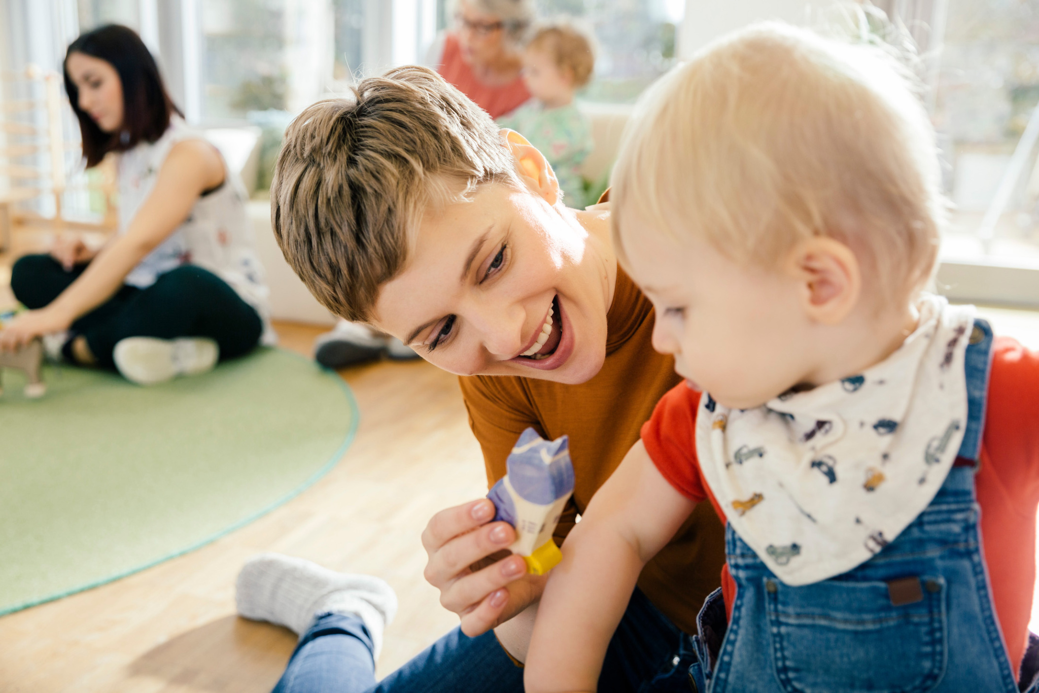 Pre-school teacher playing with toddler in Daycare center, Cologne, NRW, Germany