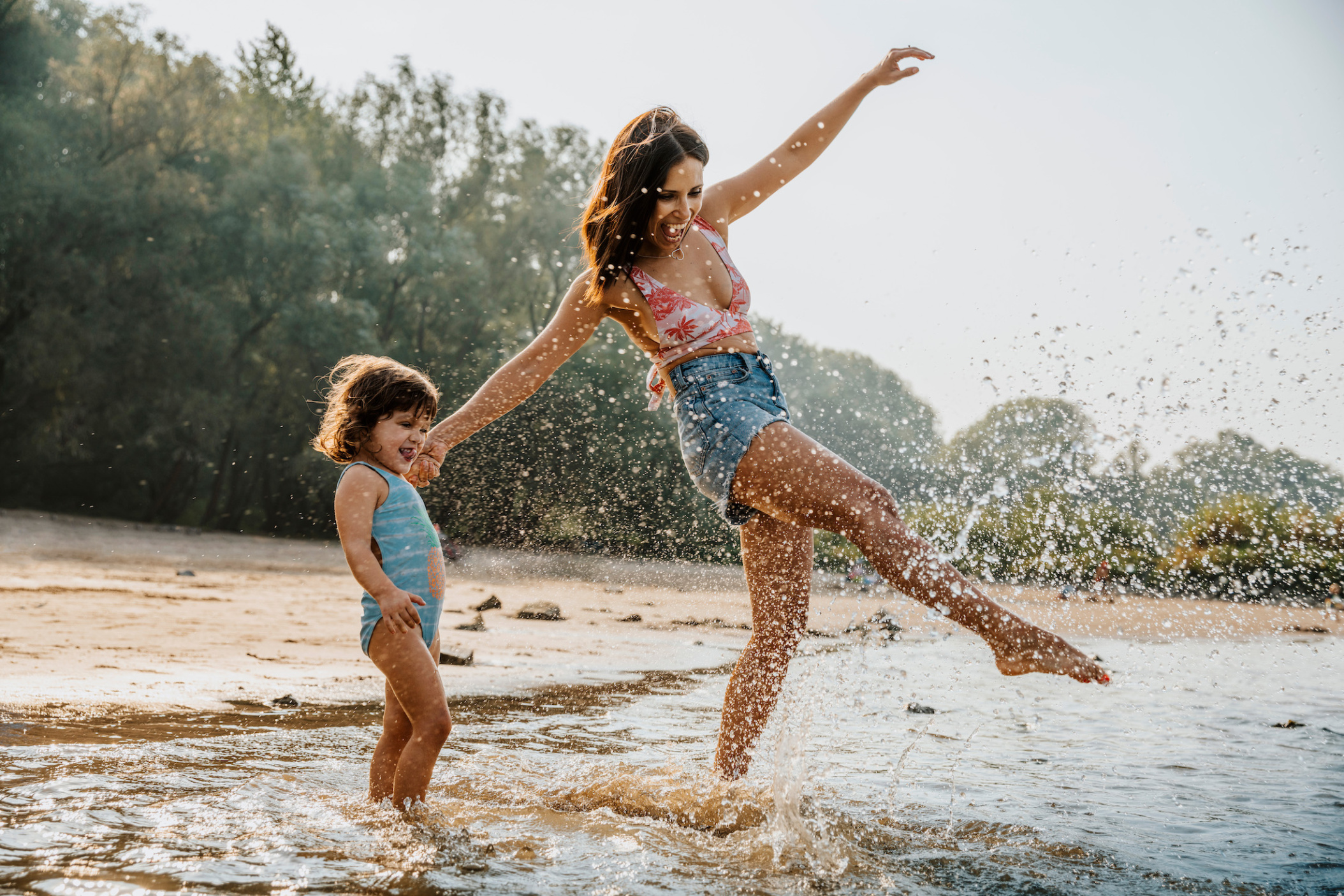 Mother and daughter enjoying the water at the beach, Cologne, NRW, Germany