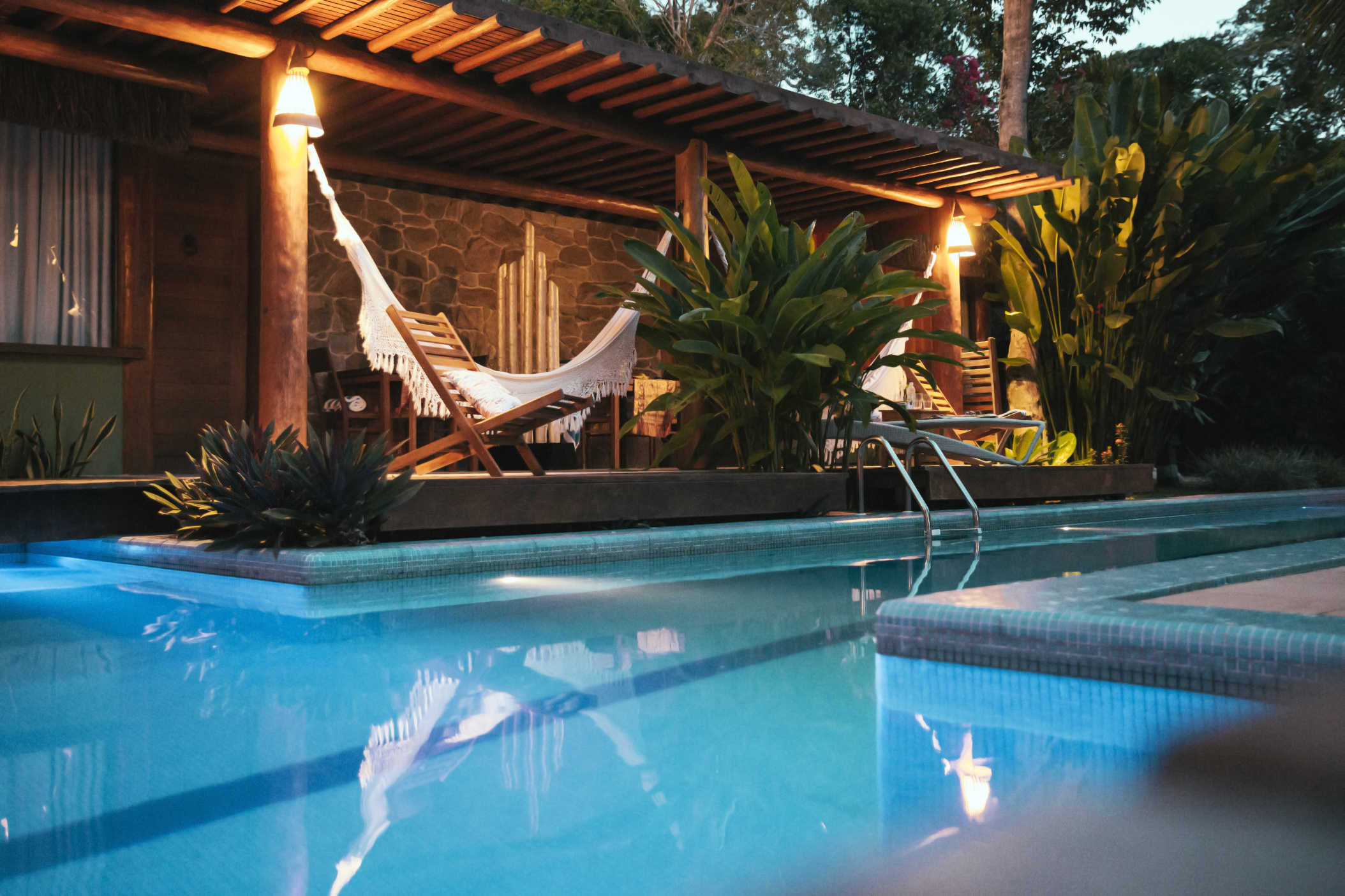 Porch of Bali style apartment hotel with hammock and swimming pool, Porto Seguro, Bahia, Brazil