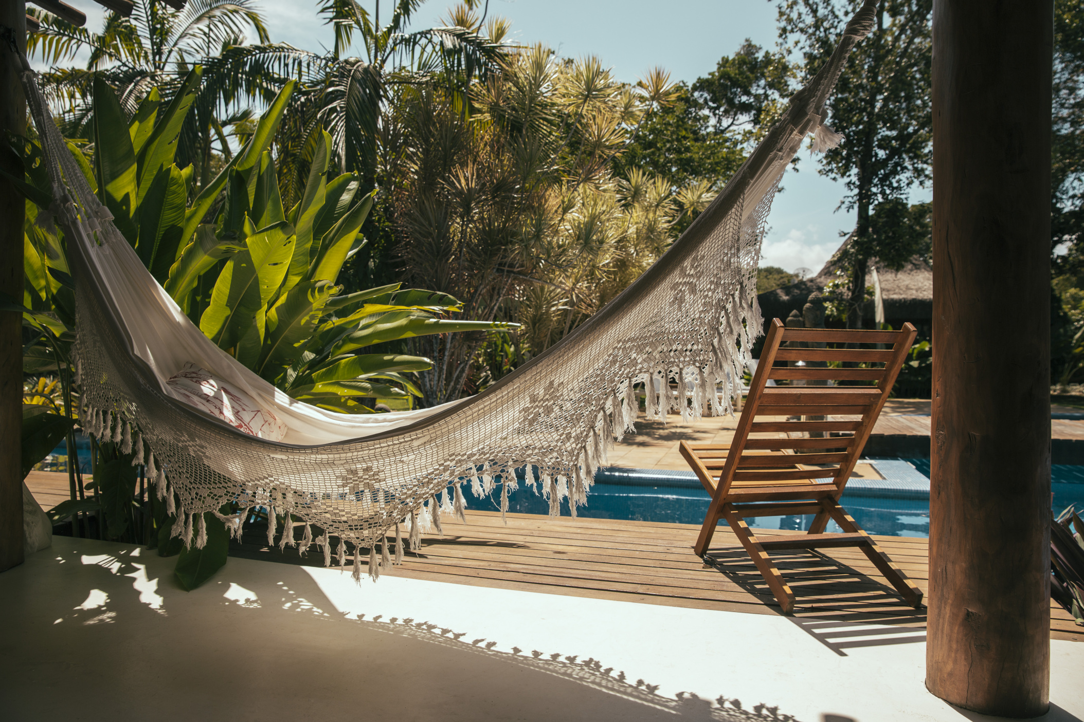 Porch of Bali style apartment hotel with hammock and swimming pool, Porto Seguro, Bahia, Brazil