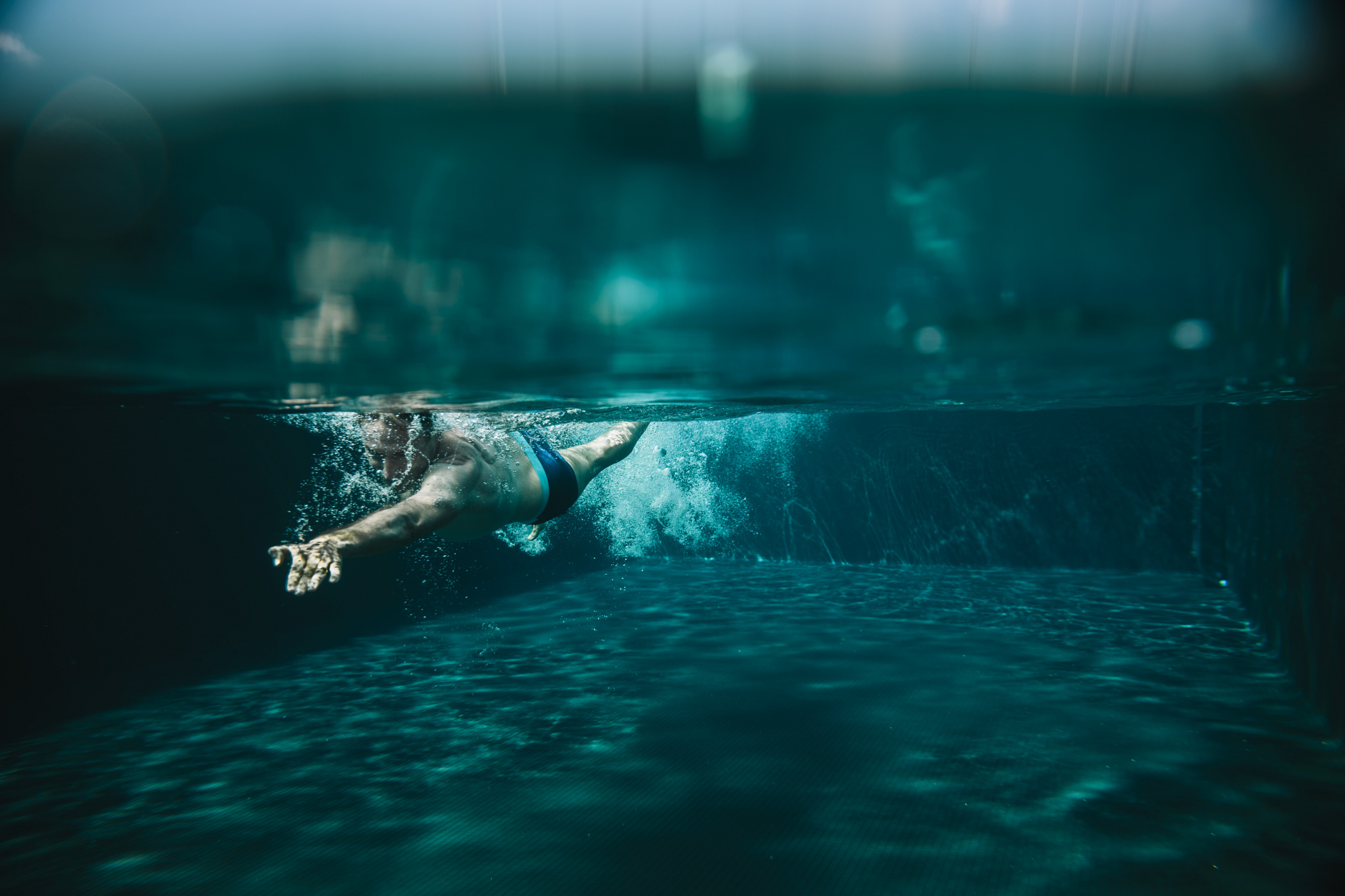 Man doing the crawl through a swimming pool, Olhao, Algarve, Portugal