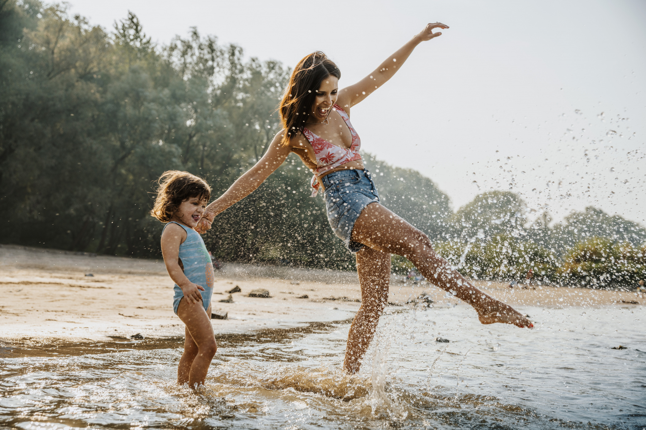 Mother and daughter enjoying the water at the beach, Cologne, NRW, Germany