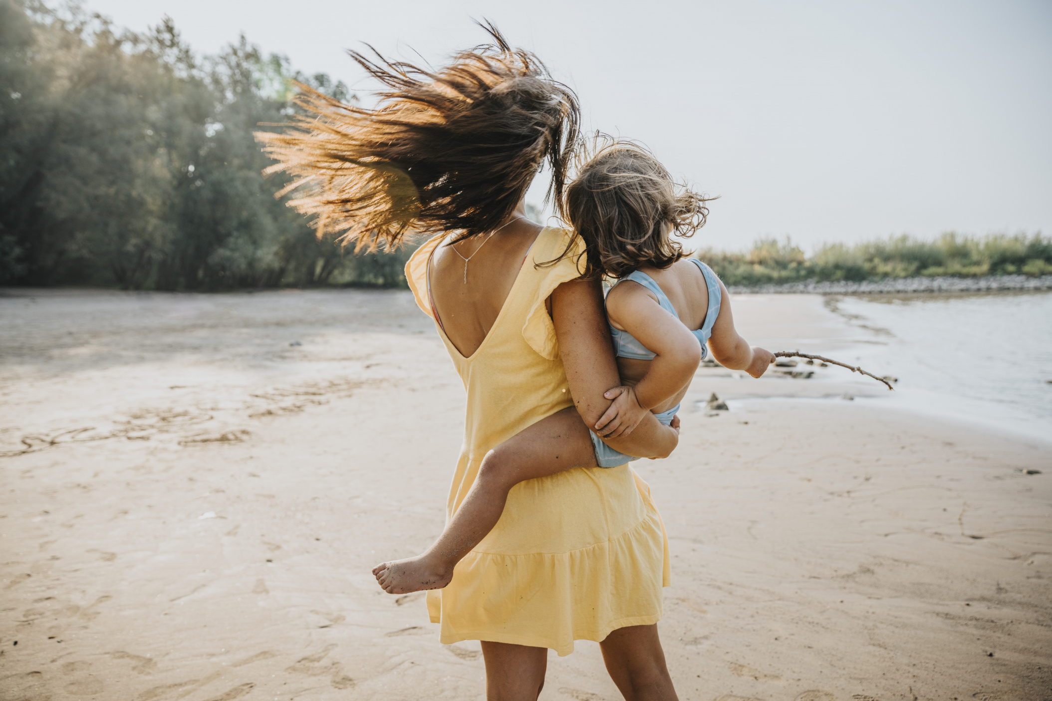 Mother and little daughter walking at the beach, Cologne, NRW, Germany