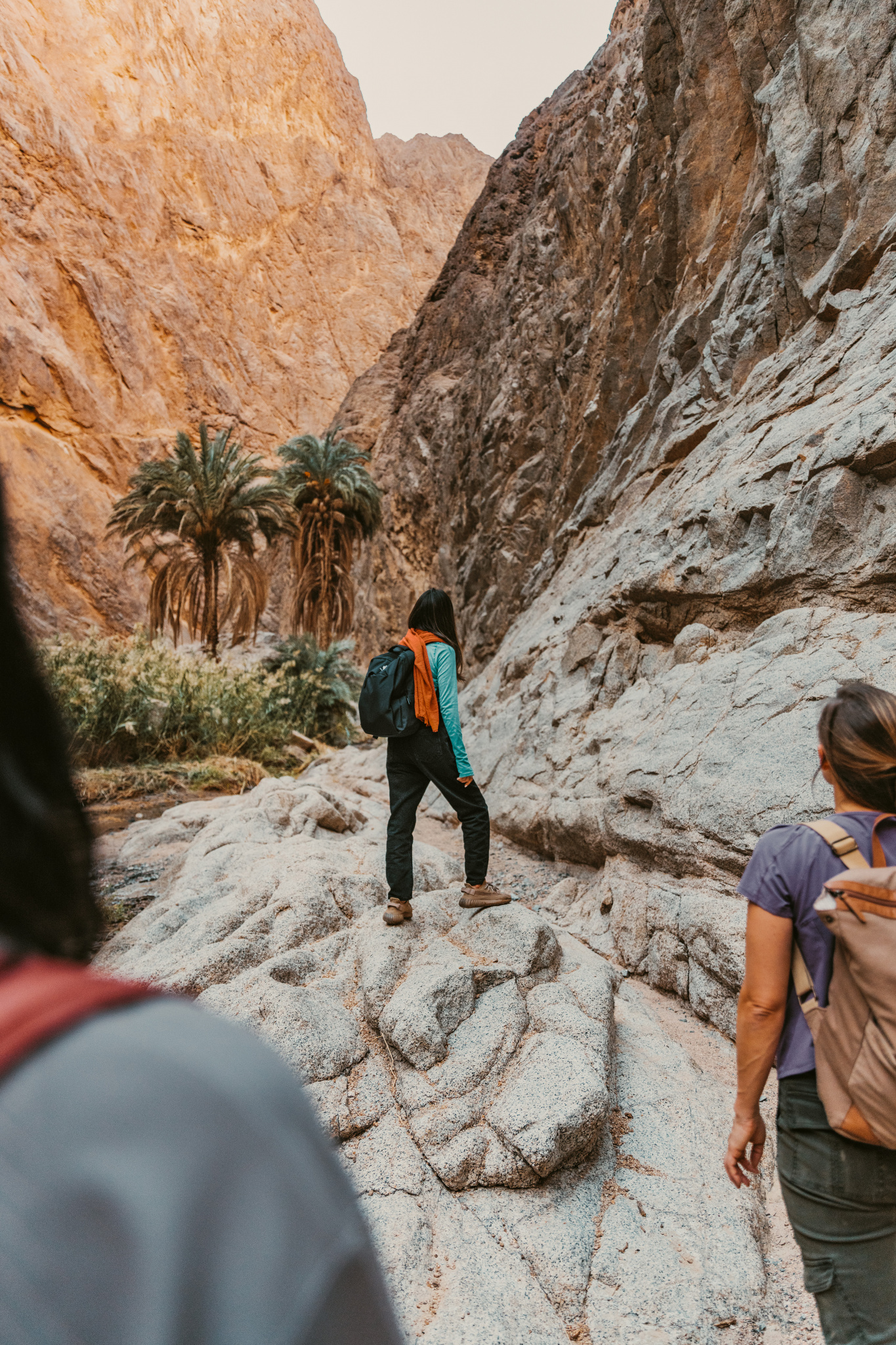 NEOM, SAUDI ARABIA – DECEMBER 11: Women walking along boulder trail in Wadi Tayyib Al Ism on December 11, 2022, in NEOM, Saudi Arabia.