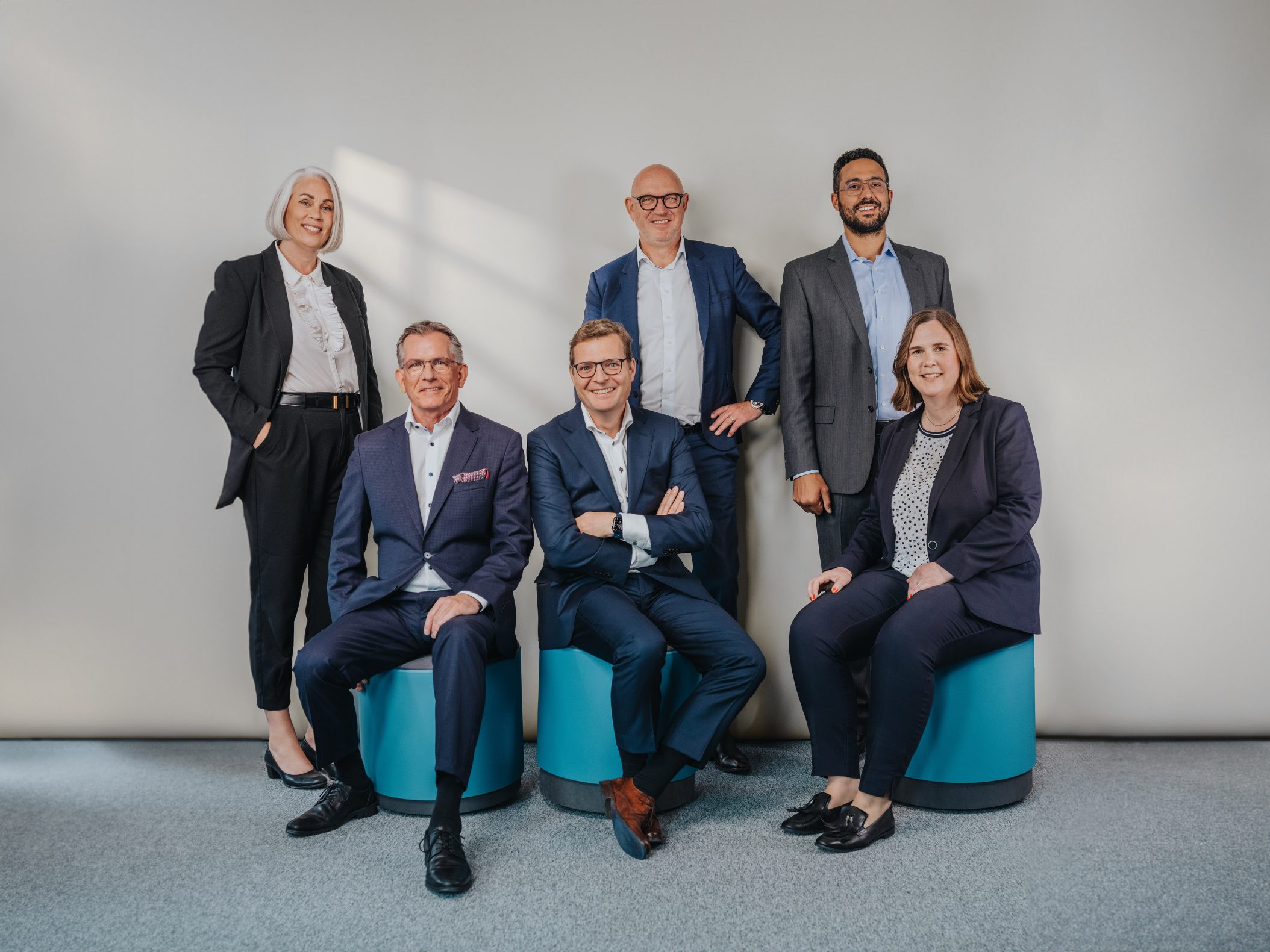 Sechsköpfiges Geschäftsteam posiert professionell im Büro